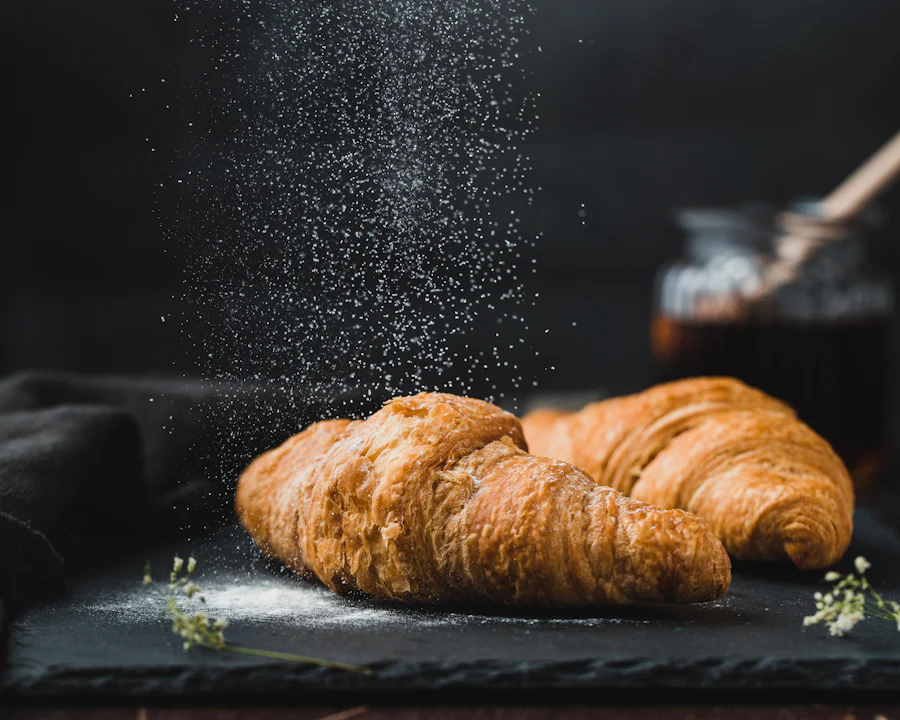 Two butter croissants dusted with flour